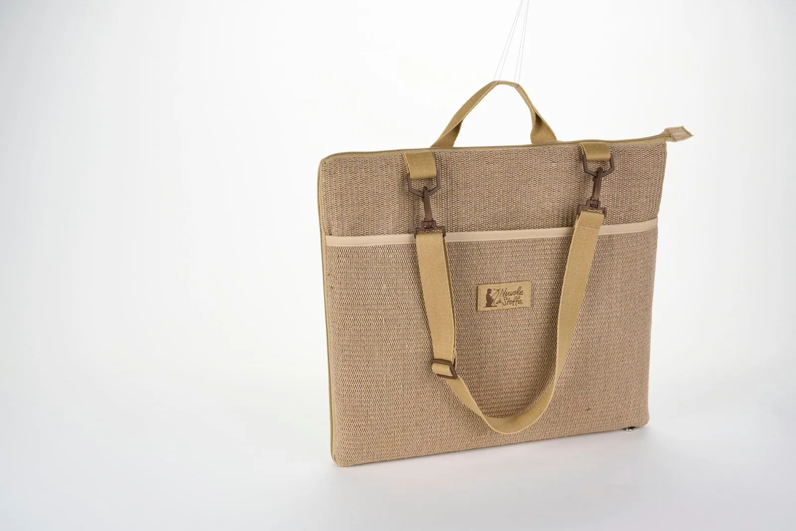 A tan woven fabric tote bag with shoulder straps