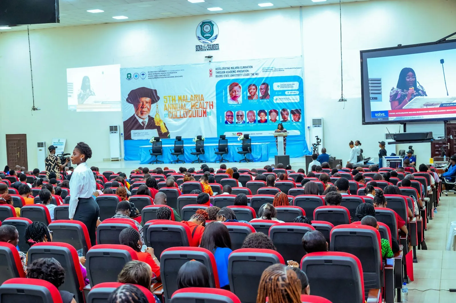 A large auditorium filled with people attending a conference