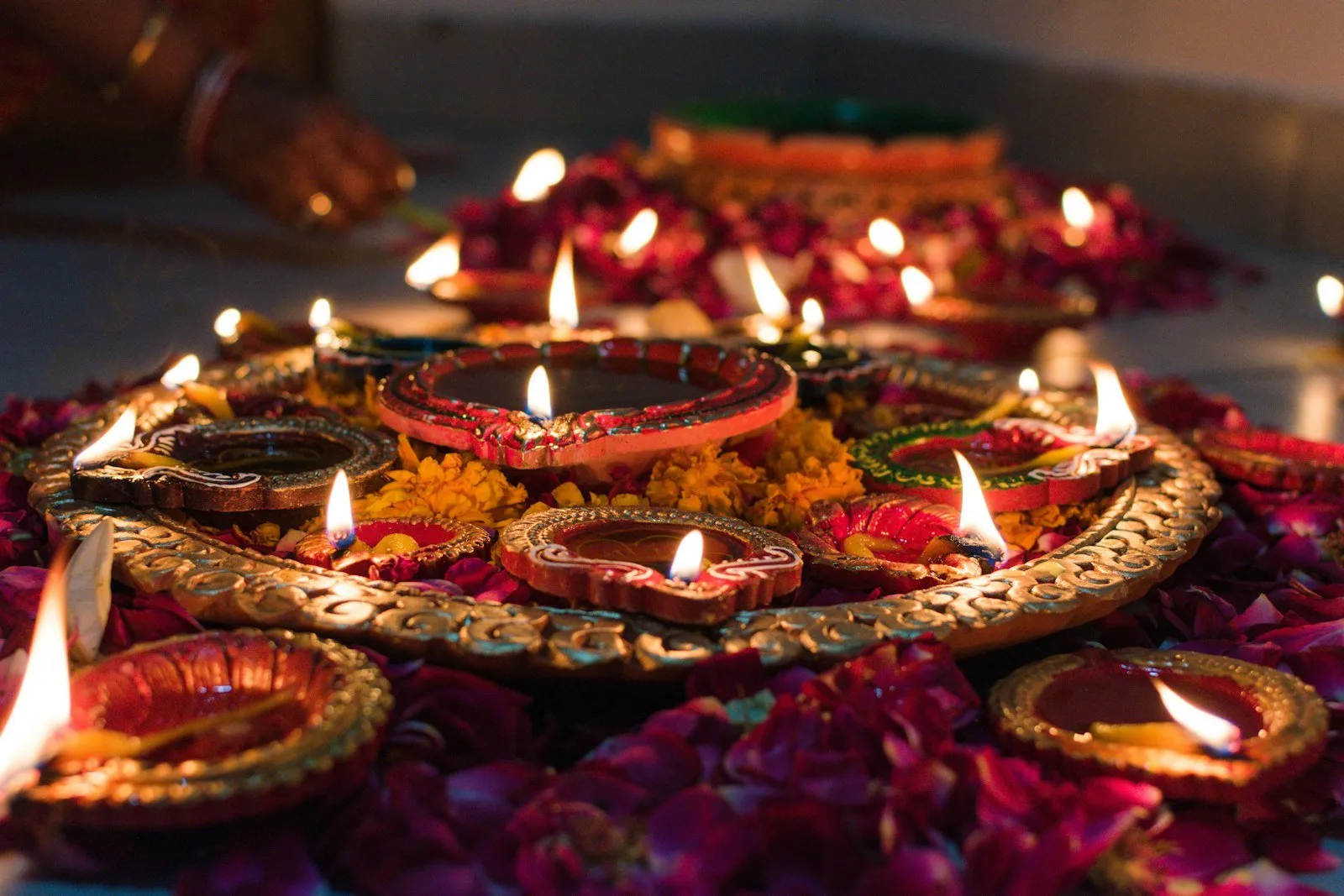 Lit clay oil lamps arranged on a decorative tray