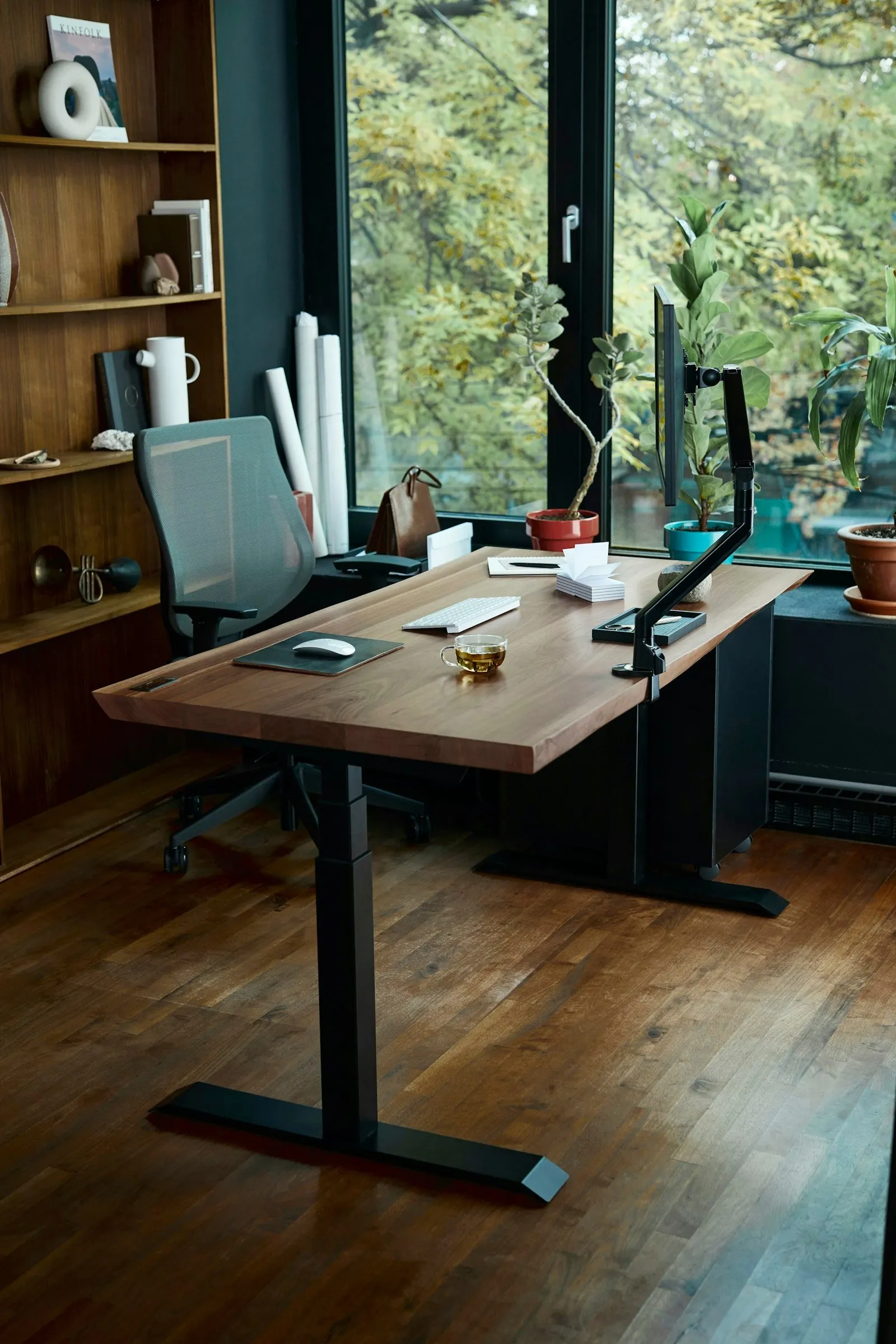 A wooden standing desk with computer monitor