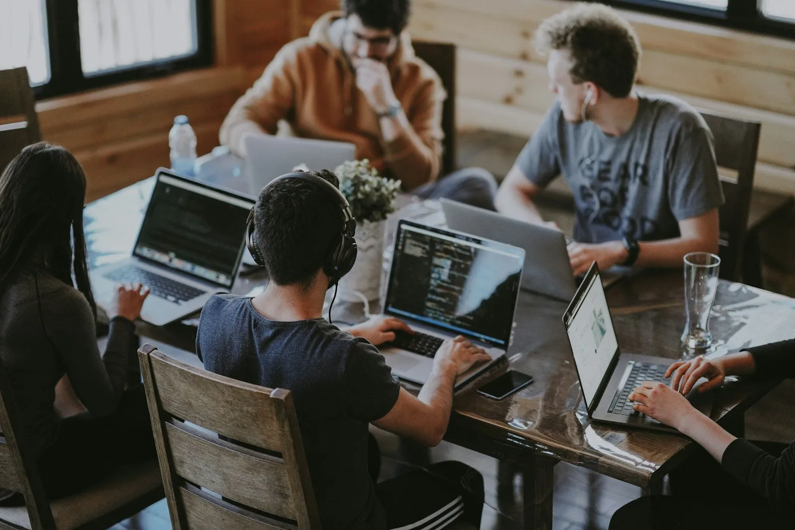 A group collaborating with laptops