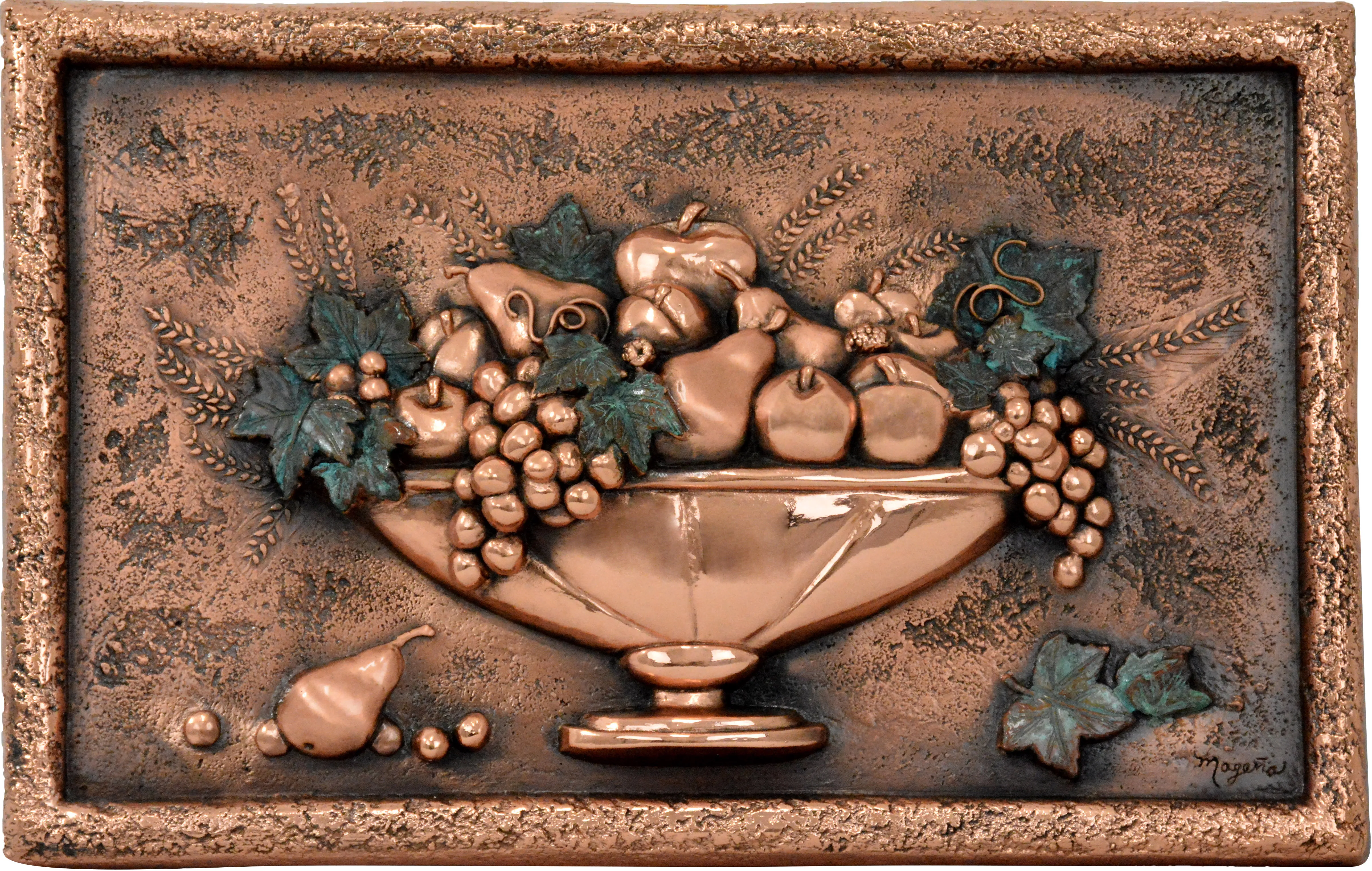 A copper relief of a footed bowl overflowing with grapes and fruit, framed by a rustic border