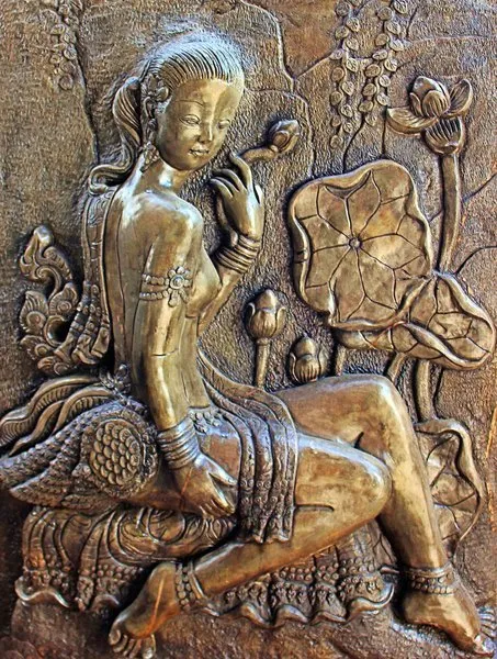 A celestial maiden sits among lotus leaves and buds in a burnished bronze relief