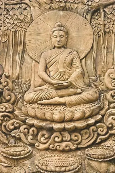 The Buddha meditates on a lotus throne, framed by a radiant halo and forest trees, in warm sand-toned relief