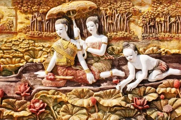 Three maidens rest beside a lotus lake under a parasol, in a richly painted gold and red relief