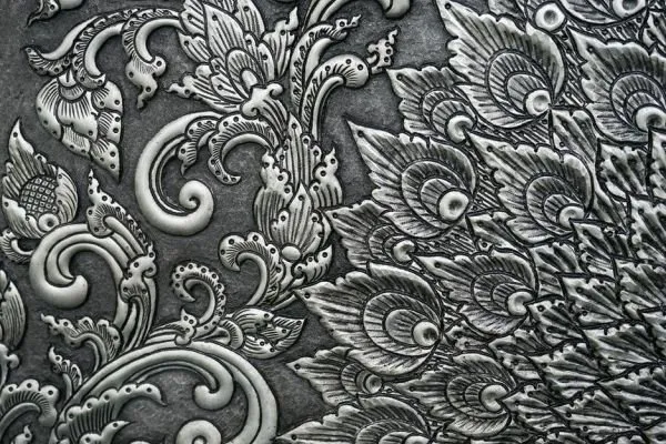 Sweeping acanthus scrolls and stylised blooms in a silver-grey damask relief
