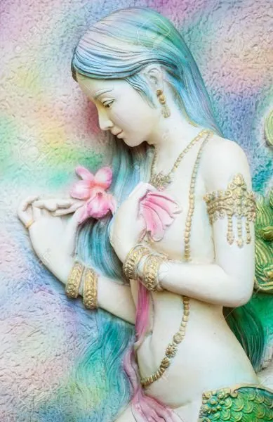 A long-haired mermaid holding pink blossoms, painted in soft rainbow pastels