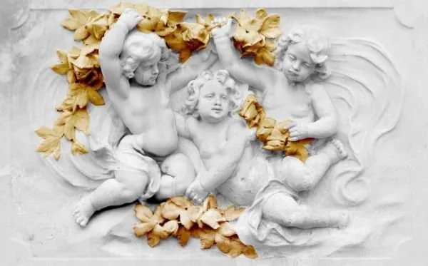 Three playful cherubs tangled in golden leaves on a soft white sculpted ground