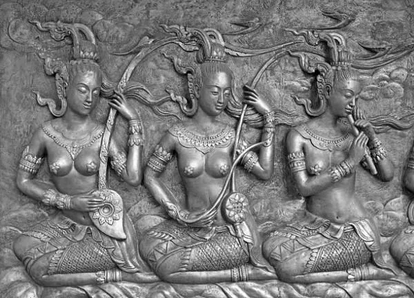 Three seated celestial musicians with lute, fiddle and flute, in silver-grey relief