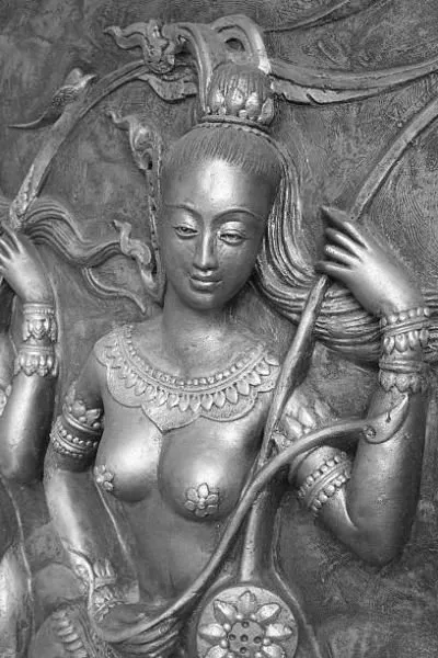 A crowned celestial maiden holding a bow and lotus wheel, in silver-grey relief