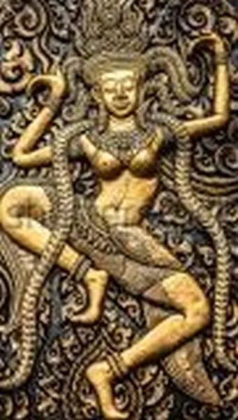 A celestial dancer in an energetic pose, framed by beaded garlands in dark bronze relief