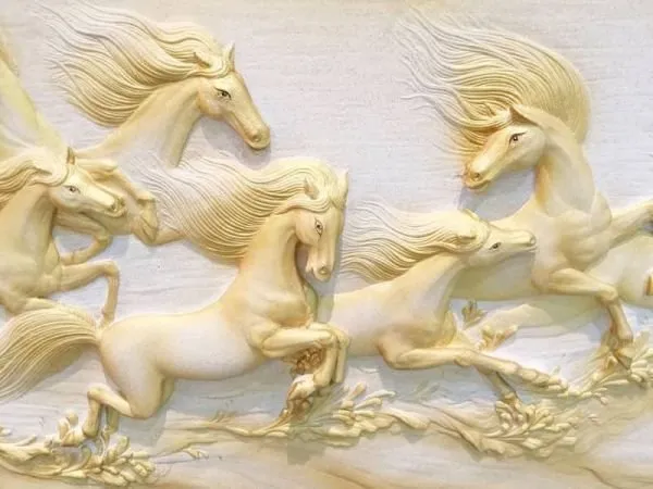 Cream horses with long, flowing manes leap across a soft white relief