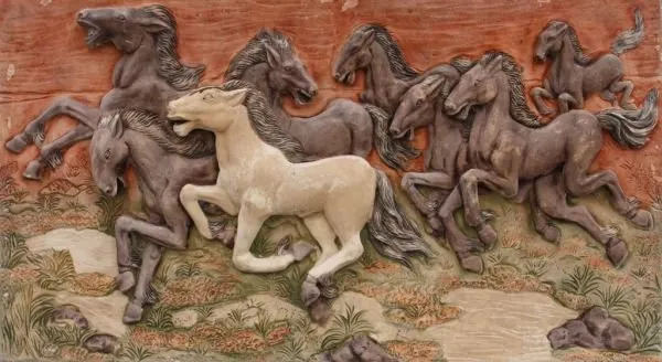 Dark brown horses gallop with a single cream horse at the centre, across a terracotta relief