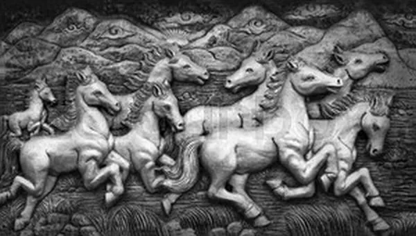 A herd of white horses gallops beneath dark hills, in a striking black-and-white relief