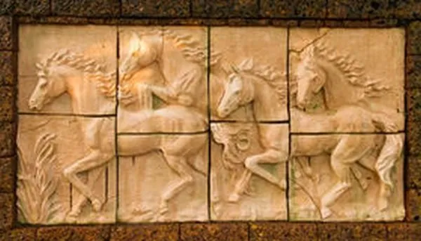 Horses with flowing manes gallop across a framed panel of sandstone-look tiles, edged in dark brick