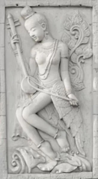 A celestial musician with a long-necked lute stands in a white carved panel