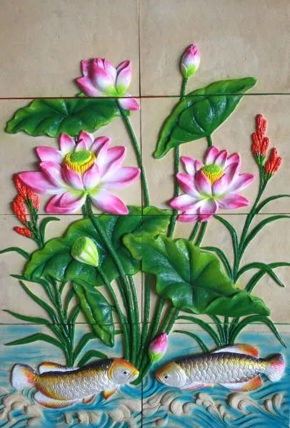 Pink lotus flowers and green leaves rise above two silver fish in a brightly painted tiled relief