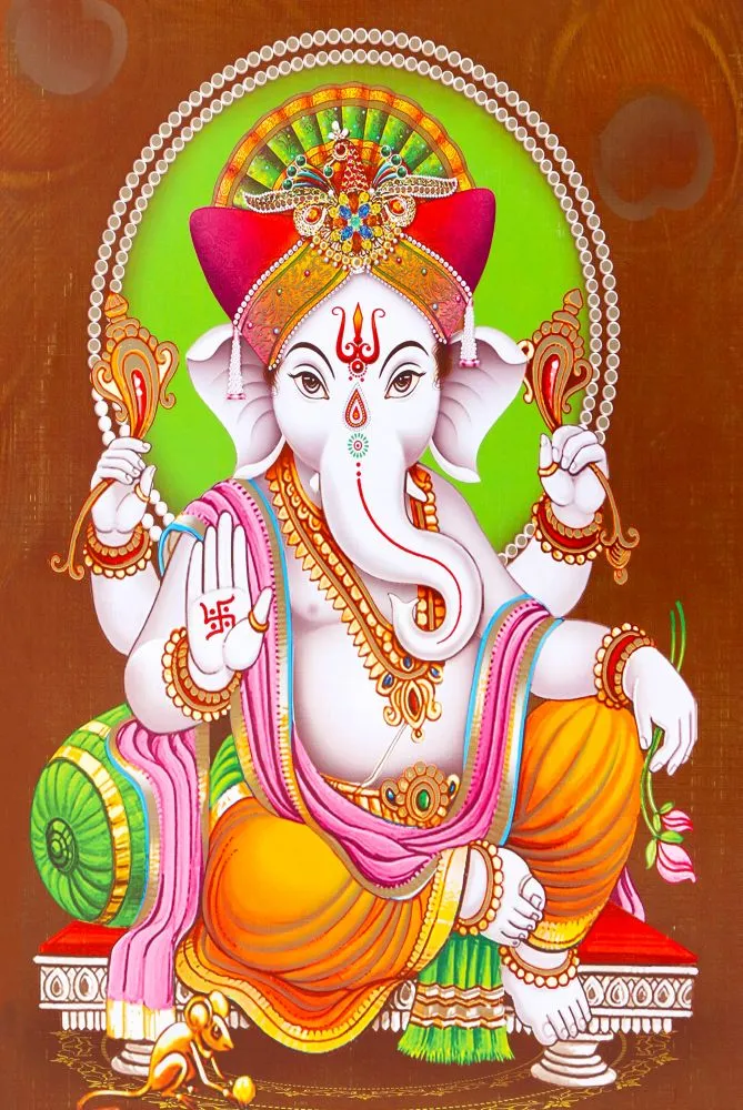 A white Ganesha seated against a green bolster, raising a hand in blessing, with a green and white halo
