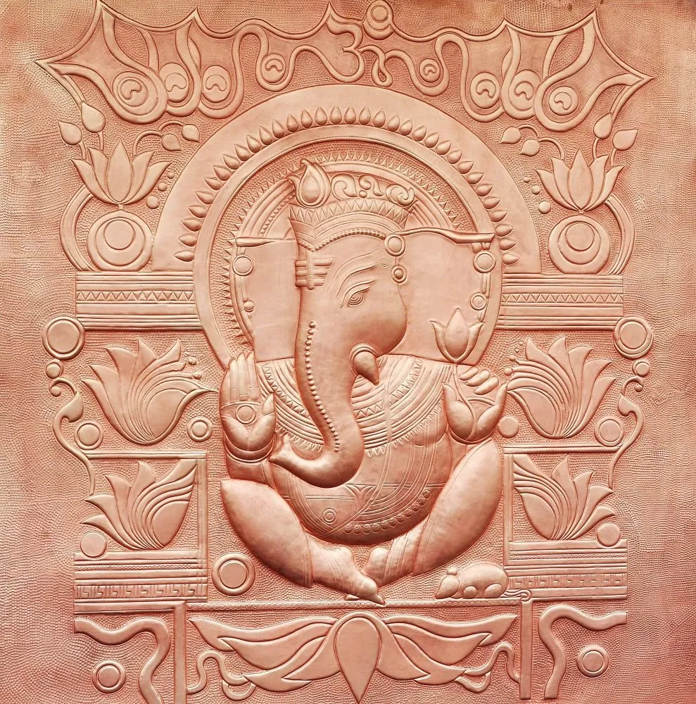 A terracotta-toned relief-style panel of a seated Ganesha within an arched niche, edged with lotus motifs