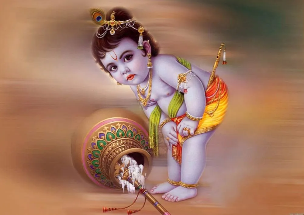 A playful baby Krishna leans over a spilled butter pot, his flute at his side, against a warm blurred background of amber and rose