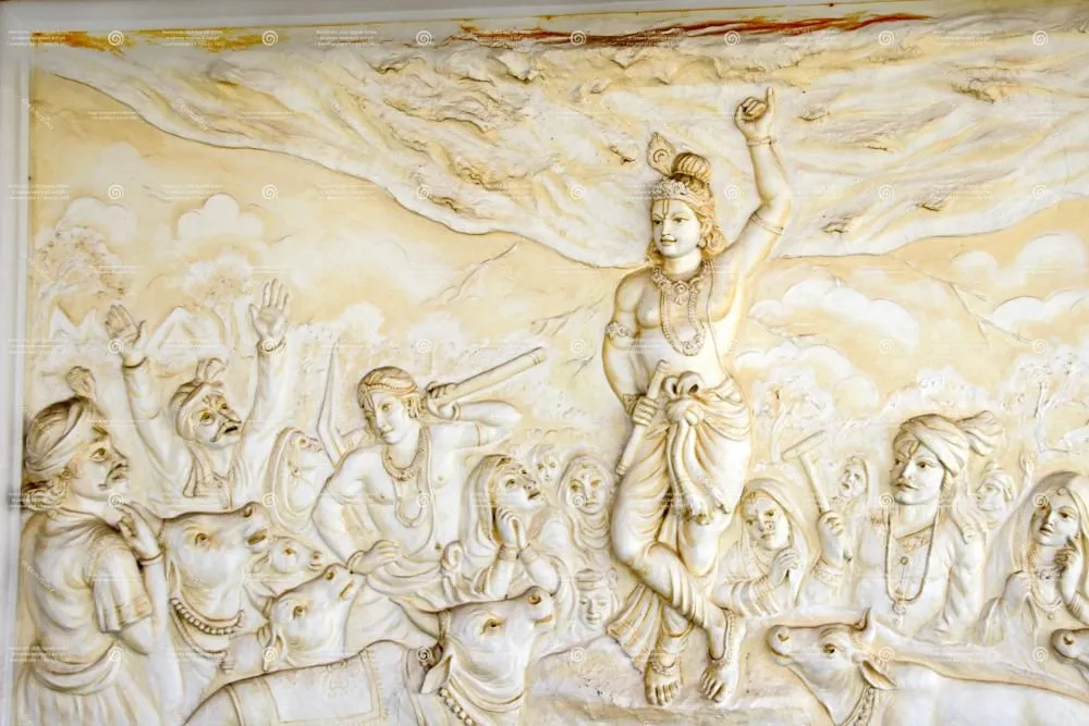A cream stone relief of Krishna lifting Govardhan hill above villagers and cattle