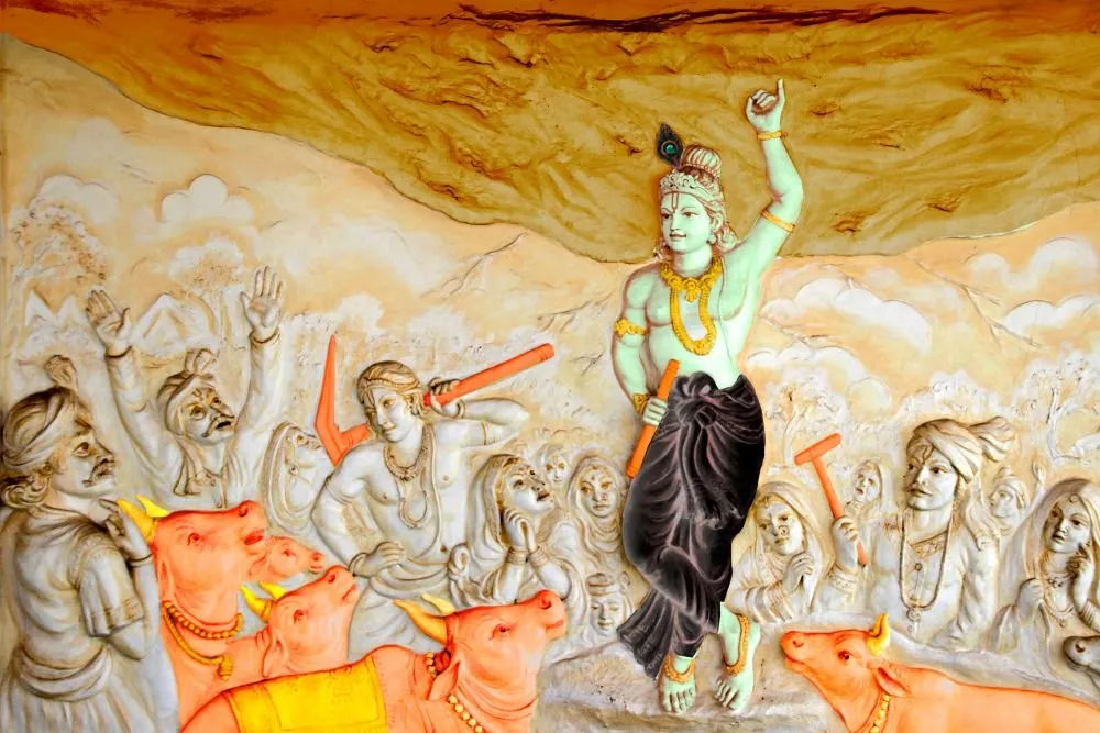 A coloured relief of Krishna lifting Govardhan hill, with villagers in sandstone and cattle picked out in orange