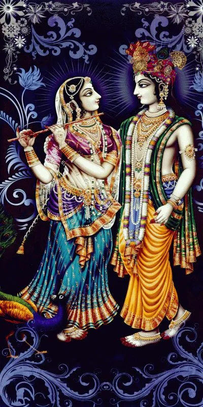 Radha and Krishna standing together in a tall frame of ornate blue scrollwork, Radha holding the flute