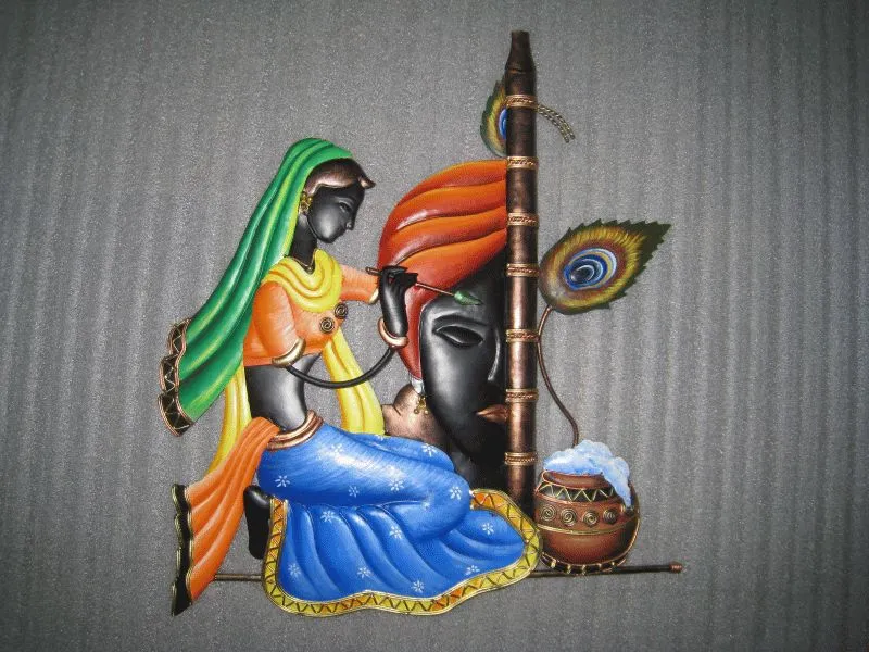 A hand-crafted style relief of Radha and a dark Krishna with his flute, a peacock feather and a clay matka