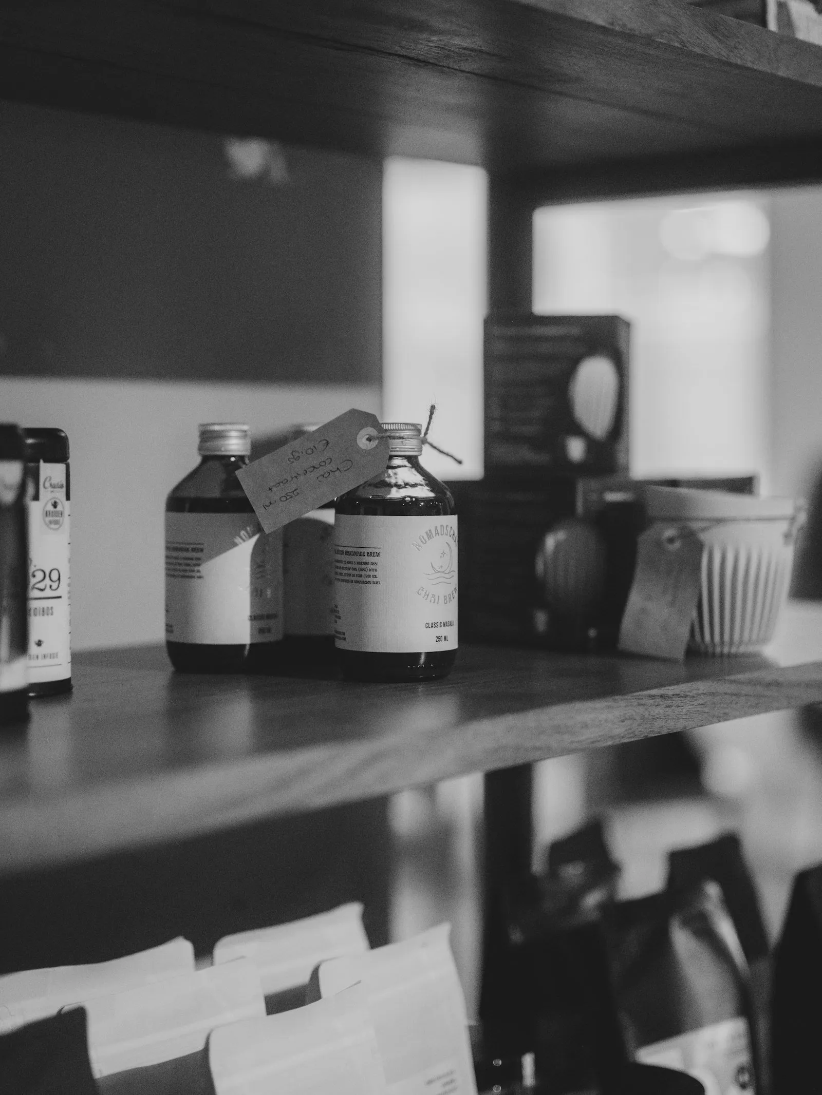 Bottles with labels on a wooden shelf