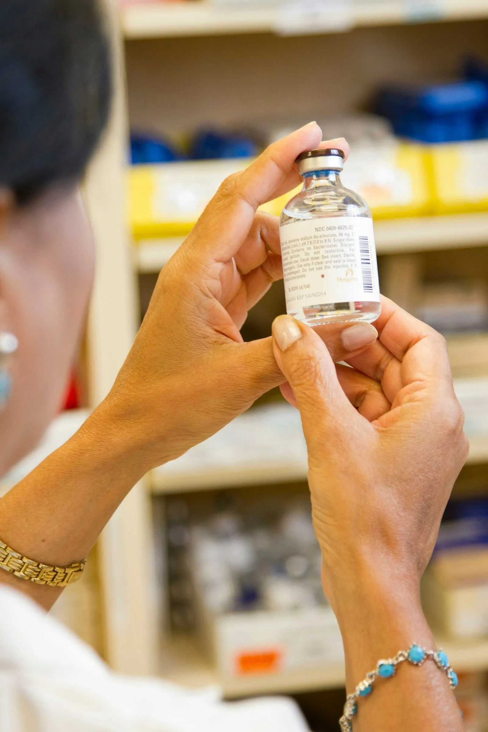 A person holding a labeled medicine bottle