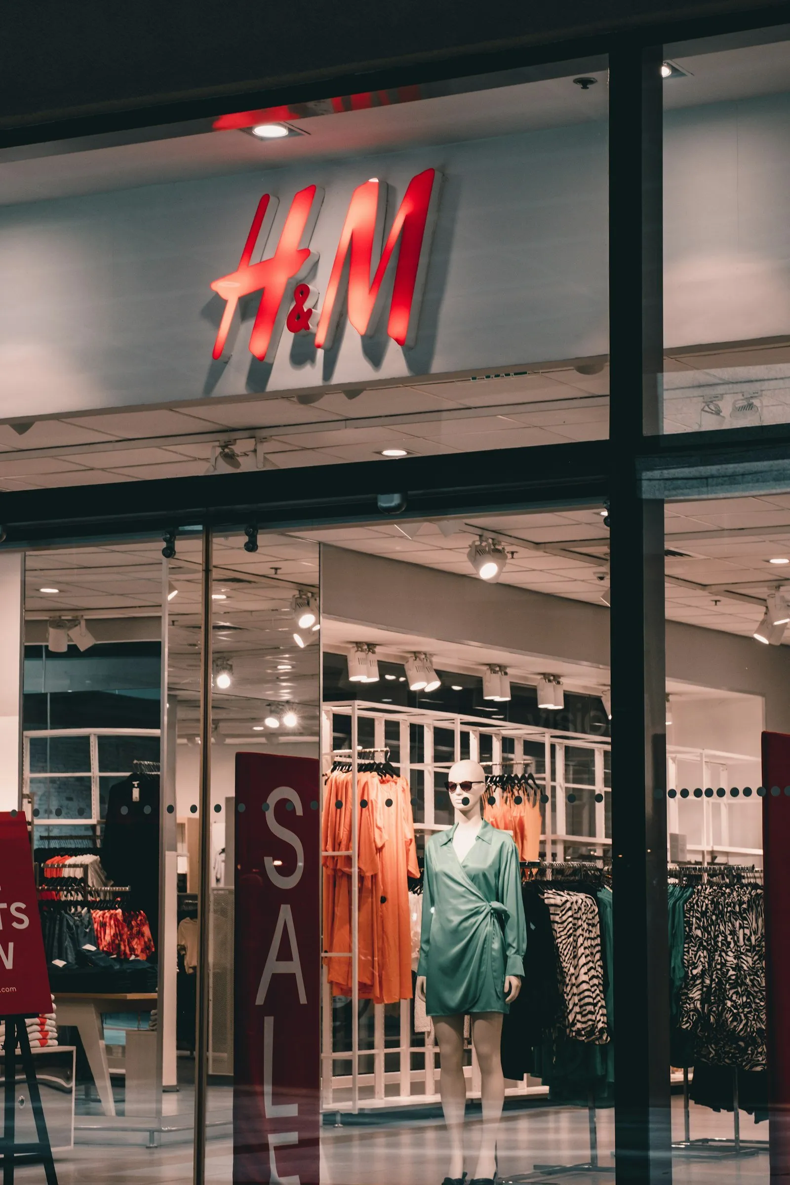 A storefront with a mannequin displayed in the window