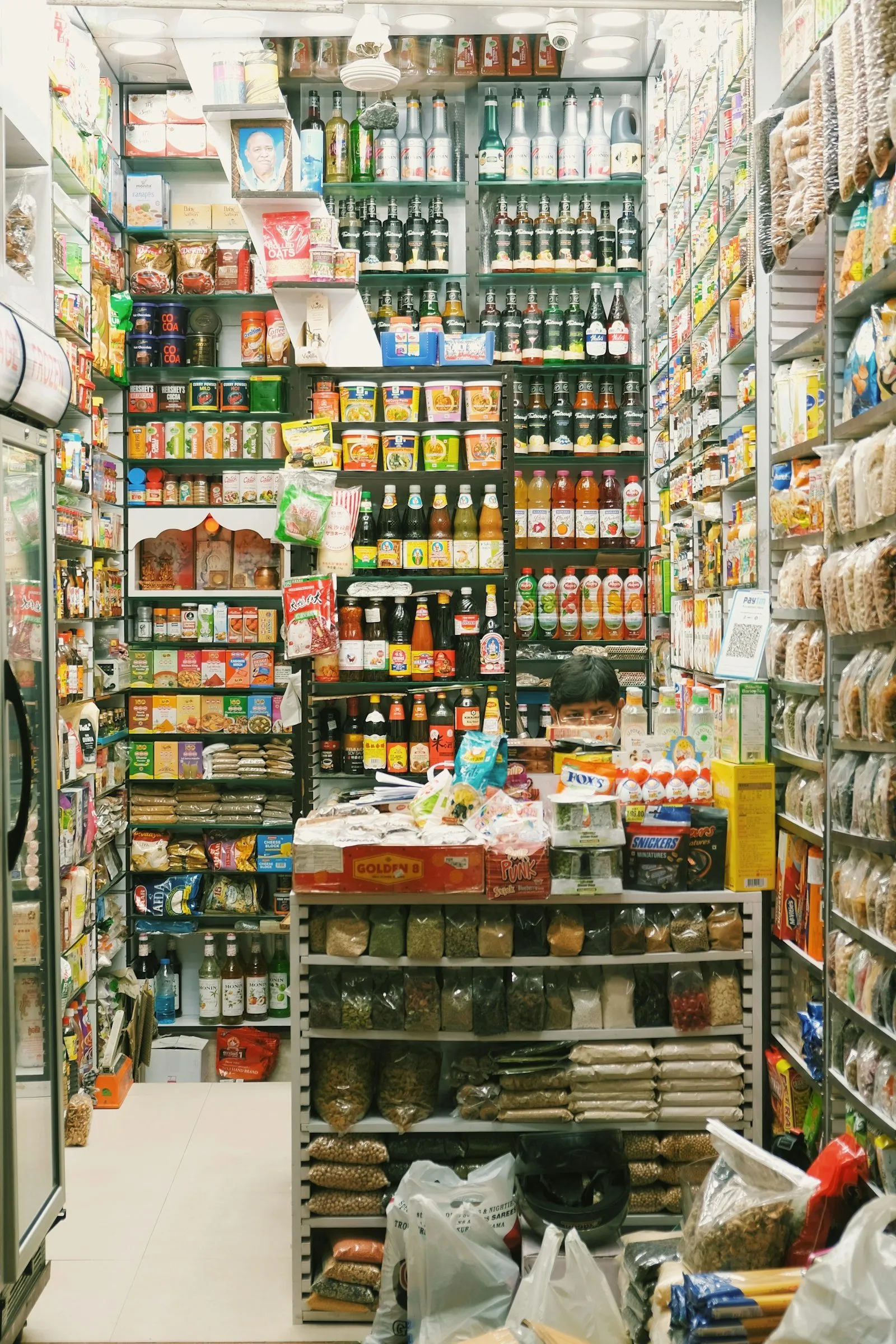 Assorted packaged food items on a small store shelf