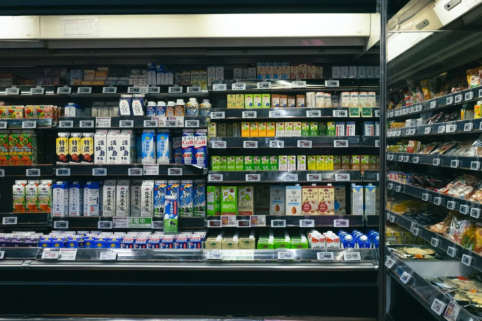 Shelves stocked with beverages and food items in a supermarket